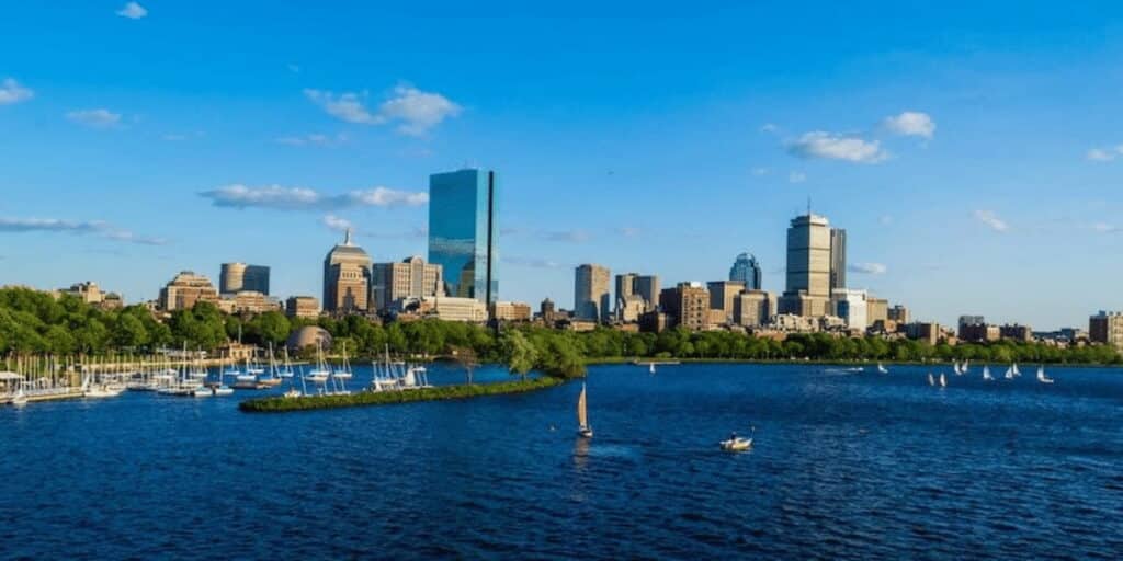 Floating solar panels on a large water body near an urban area, representing innovative renewable energy solutions supported by Massachusetts solar incentives.