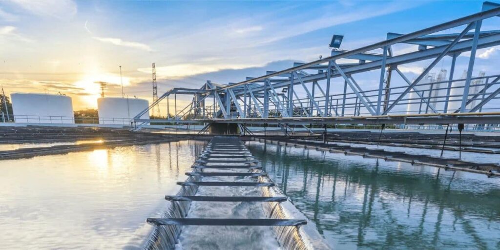 Industrial water treatment facility at sunset utilizing PFAS treatment technologies to purify contaminated water.