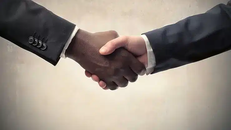 two people shaking hands after agreeing to a job in the solar industry